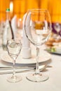 Table setting with sparkling wineglasses, plate with white napkin and cutlery on table, copy space. Royalty Free Stock Photo