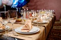 Table setting with sparkling wineglasses, plates with napkins and cutlery on table, copy space. Royalty Free Stock Photo