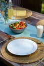 Table setting at a summer garden party. Garden party table with fresh vegetable salat, glasses, lemonade, fresh fruits