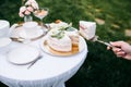 Table setting, tea party, female hand takes cake