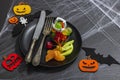 Table setting, traditional festive composition for Halloween party. Funny seasonal props