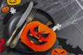 Table setting, traditional festive composition for Halloween party. Funny seasonal props