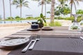 Table setting in tropical resort. Table set near resort pool. Cutlery on table of outdoor restaurant. Royalty Free Stock Photo