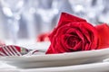 Table setting for valentines or wedding day with red roses. Romantic table setting for two with roses plates cups and cutlery Royalty Free Stock Photo