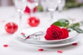 Table setting for valentines or wedding day with red roses. Romantic table setting for two with roses plates cups and cutlery Royalty Free Stock Photo