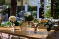 Table setting with vases with flowers and candles, chair on the background Royalty Free Stock Photo