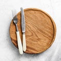 Table setting with vintage cutlery and wooden plate Royalty Free Stock Photo