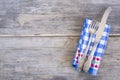 Table setting with vintage fork and knife on blue and white checkered napkin on old wooden background Royalty Free Stock Photo