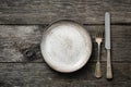 Table setting with vintage silverware or cutlery and empty plate on rustic wood Royalty Free Stock Photo