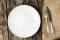 Table setting with vintage silverware or cutlery and empty plate on rustic wood. Top view. Royalty Free Stock Photo