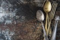 Table setting in vintage style. Antique fork, knife, spoon on old dark  background. Space for text, flat lay Royalty Free Stock Photo