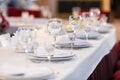 Table settings with white wine glasses and glasses of spirits. Wedding decor, restaurant layout.