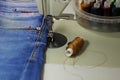 On the table of the sewing machine lie denim fabrics, close-up, Royalty Free Stock Photo