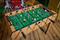 Table soccer. Foosball in a children`s playroom. Close-up during the game. Soccer table kid`s home toys, football family game Royalty Free Stock Photo