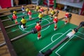 Table soccer. Foosball in a children`s playroom. Close-up during the game. Soccer table kid`s home toys, football family game Royalty Free Stock Photo