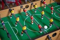 Table soccer. Foosball in a children`s playroom. Close-up during the game. Soccer table kid`s home toys, football family game Royalty Free Stock Photo