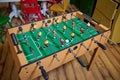 Table soccer. Foosball in a children`s playroom. Close-up during the game. Soccer table kid`s home toys, football family game Royalty Free Stock Photo