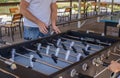 Table soccer. Foosball in a childrens playroom. Close-up during the game. Soccer table kids home toys, football family game table Royalty Free Stock Photo