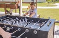 Table soccer. Foosball in a childrens playroom. Close-up during the game. Soccer table kids home toys, football family game table Royalty Free Stock Photo