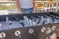 Table soccer. Foosball in a childrens playroom. Close-up during the game. Soccer table kids home toys, football family game table Royalty Free Stock Photo