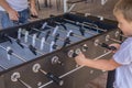 Table soccer. Foosball in a childrens playroom. Close-up during the game. Soccer table kids home toys, football family game table Royalty Free Stock Photo