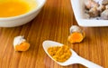 A table spoon of Pure Turmeric Haldi Spices Powder, oil and water. Haldi ceremony or pre-wedding or first wedding ritual in