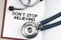 On the table is a stethoscope, a pen and a notebook in which it is written - Dont Stop Believing Royalty Free Stock Photo