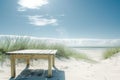 table on a sunny beach with dune grass behind Royalty Free Stock Photo