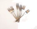 A table surface with a set of silver dinner forks arranged in a fan shape Royalty Free Stock Photo