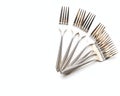 A table surface with a set of silver dinner forks arranged in a fan shape Royalty Free Stock Photo