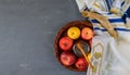 On the table in the synagogue are the symbols of Rosh Hashanah apple and pomegranate, shofar talith