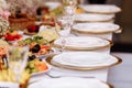 a table with a tablecloth, a beautiful serving of white dishes, a beautiful plate, dinner in a restaurant Royalty Free Stock Photo