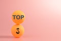 Table tennis ball with text TOP 3 isolated on pink background