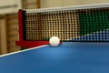 Table tennis balle and net.Competitive player