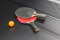Table tennis racket with ball on black table Royalty Free Stock Photo