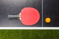 Table tennis racket with ball on black table Royalty Free Stock Photo