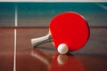 Table tennis racket and ball, net background Royalty Free Stock Photo