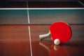 Table tennis racket and ball, net background Royalty Free Stock Photo