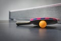 Table tennis racket with orange ball Royalty Free Stock Photo