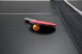 Table tennis racket with orange ball Royalty Free Stock Photo