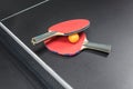 Table tennis racket with orange ball on black Royalty Free Stock Photo