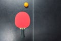 Table tennis racket with orange ball on table Royalty Free Stock Photo