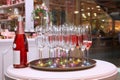 On the table there are many beautiful glasses of champagne and a bottle of wine Royalty Free Stock Photo