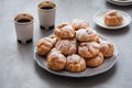 On the table there is a plate of profiteroles