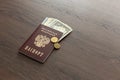 On the table there is a Russian passport inside various dollar bills and small change. finance Royalty Free Stock Photo