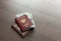 On the table there is a Russian passport inside various dollar bills and small change. finance Royalty Free Stock Photo