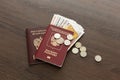 On the table there is a Russian passport inside various Russian ruble bills and small change. Departure abroad Royalty Free Stock Photo