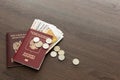 On the table there is a Russian passport inside various Russian ruble bills and small change. Departure abroad Royalty Free Stock Photo