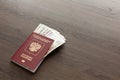 On the table there is a Russian passport inside various Russian ruble bills and small change. Departure abroad Royalty Free Stock Photo