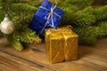 On the table there are two gifts - yellow and mini next to the fir tree. Christmas gifts. Colors of the flag of Ukraine. gifts for